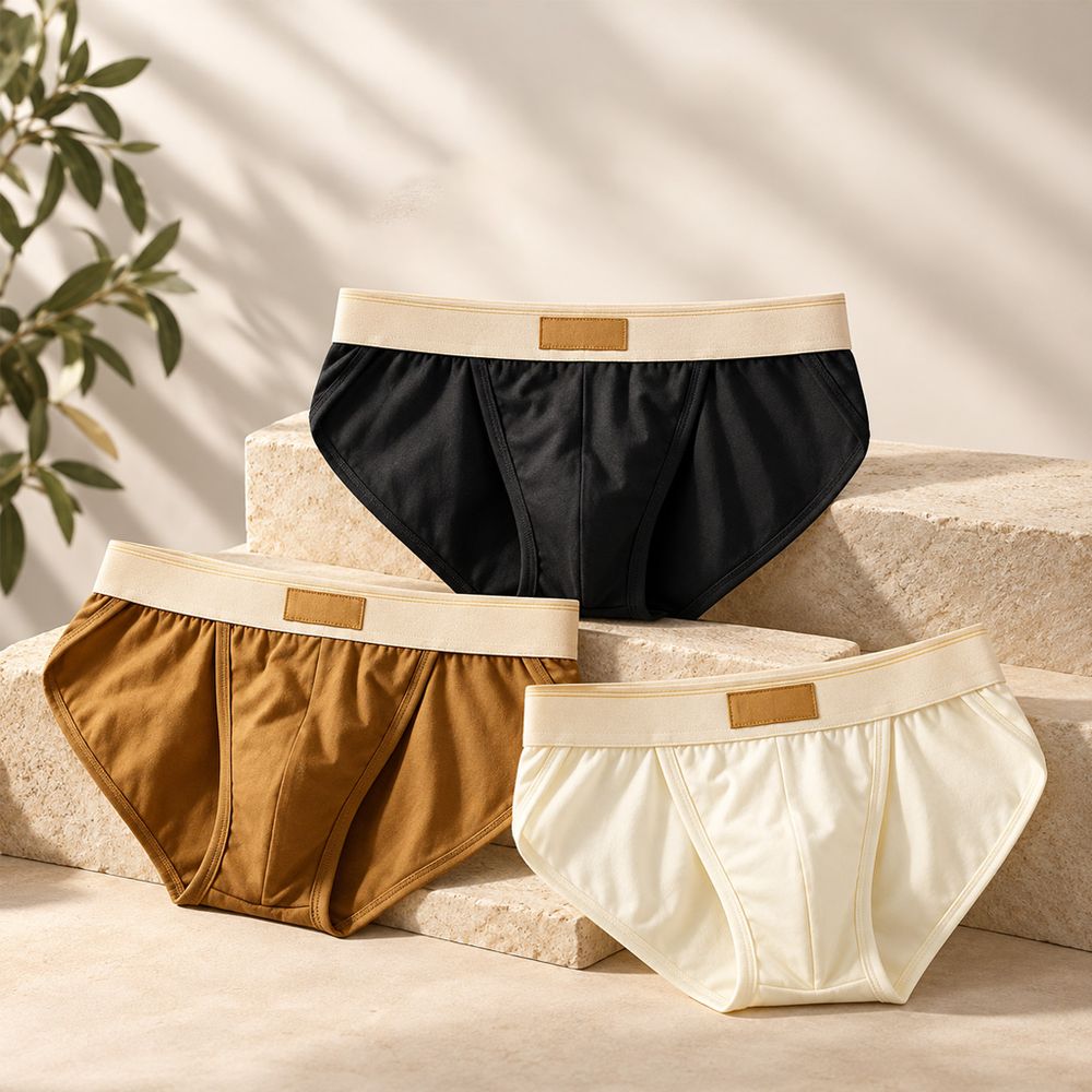 Three cotton briefs in black, brown and white with a wide band